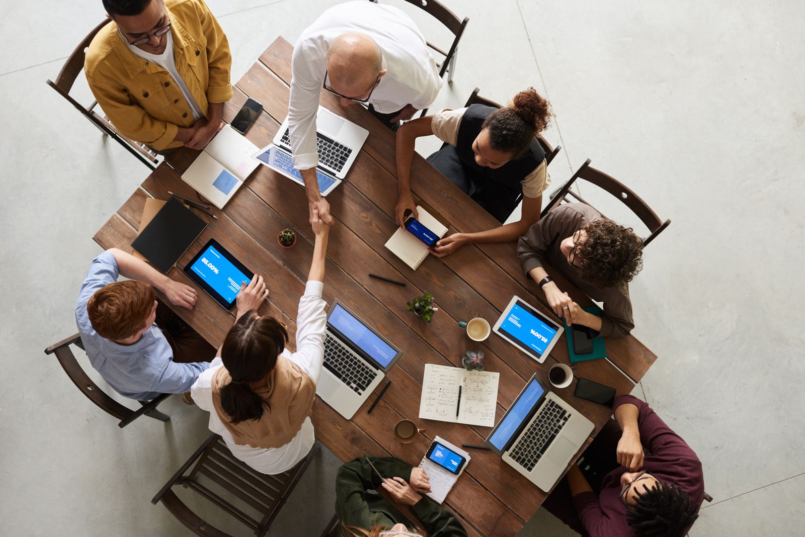 A diverse team reviewing offers and closing a deal
