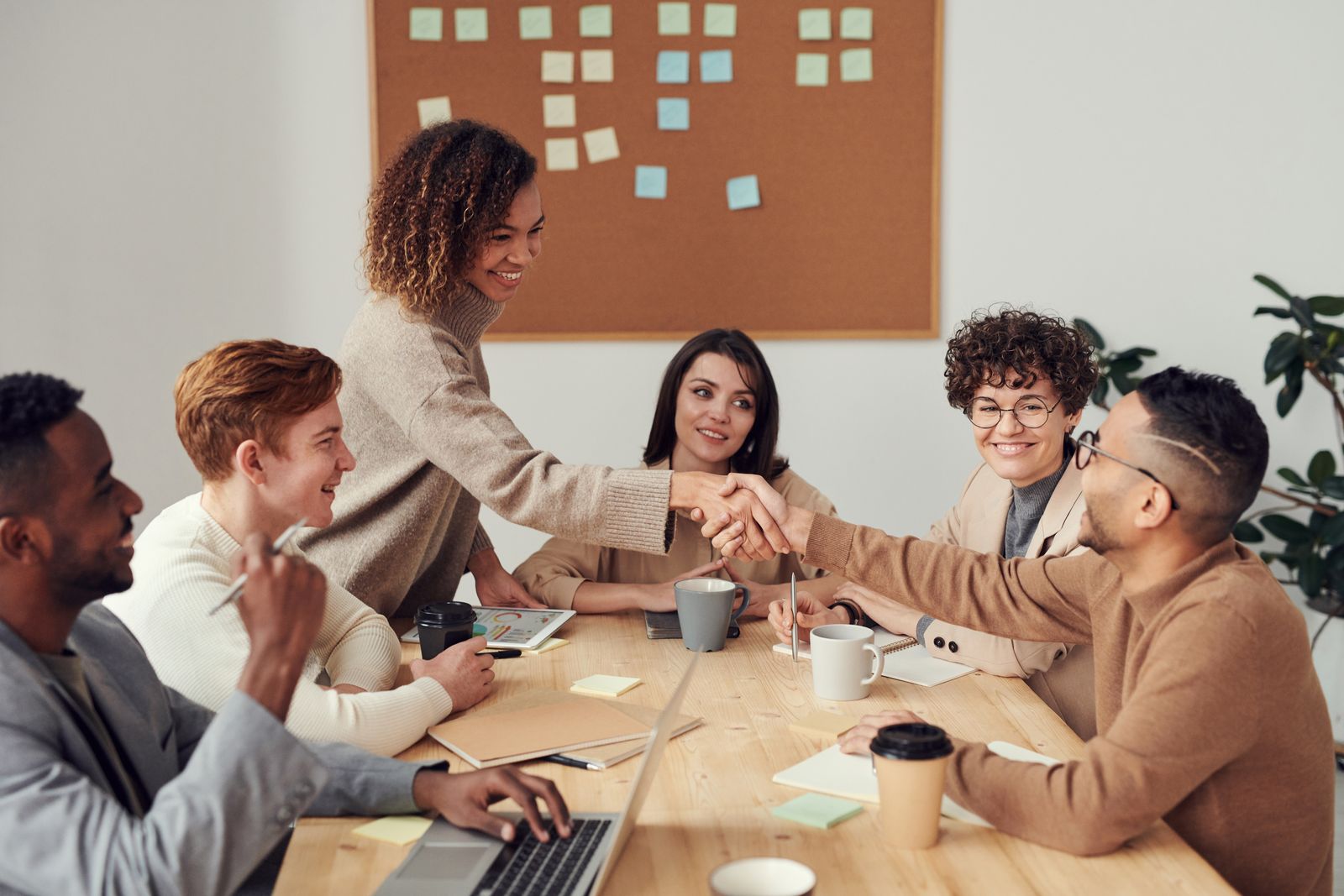 A business and a creator shaking hands over a deal