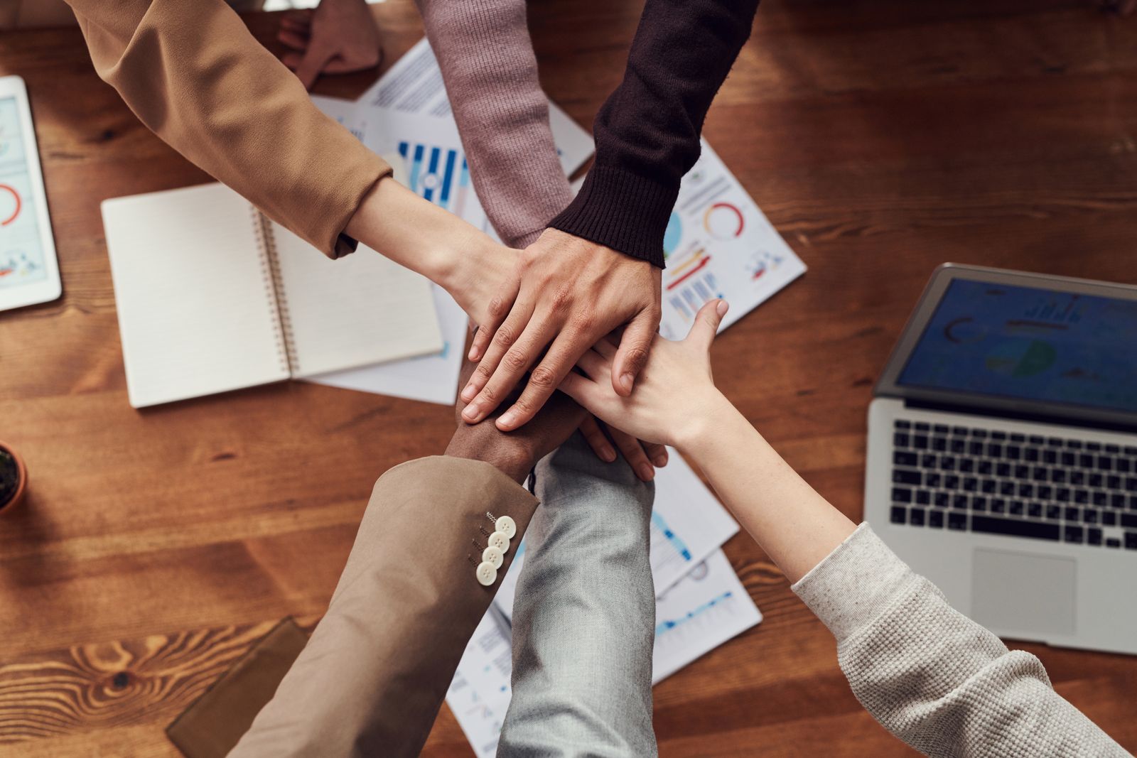 Hands coming together over a shared plan: partnership